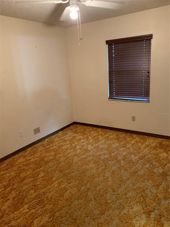 4661 Anderson Road, Unit 4661 Kissimmee, FL 34746 - Photo 9 of 14 an empty room with a window