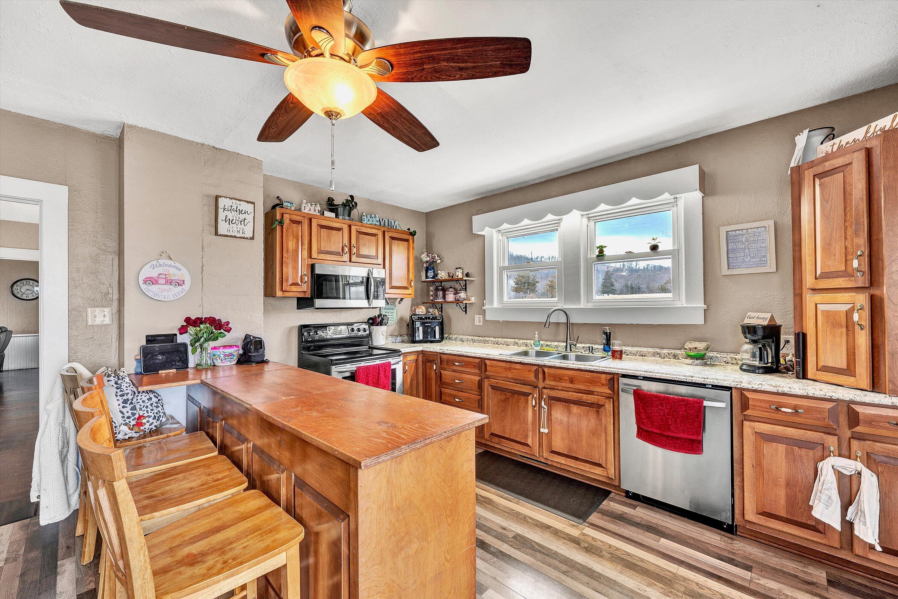 1045 Emerald Drive Goodview, VA 24095 - Photo 12 of 46 a kitchen with stainless steel appliances granite countertop a sink and cabinets