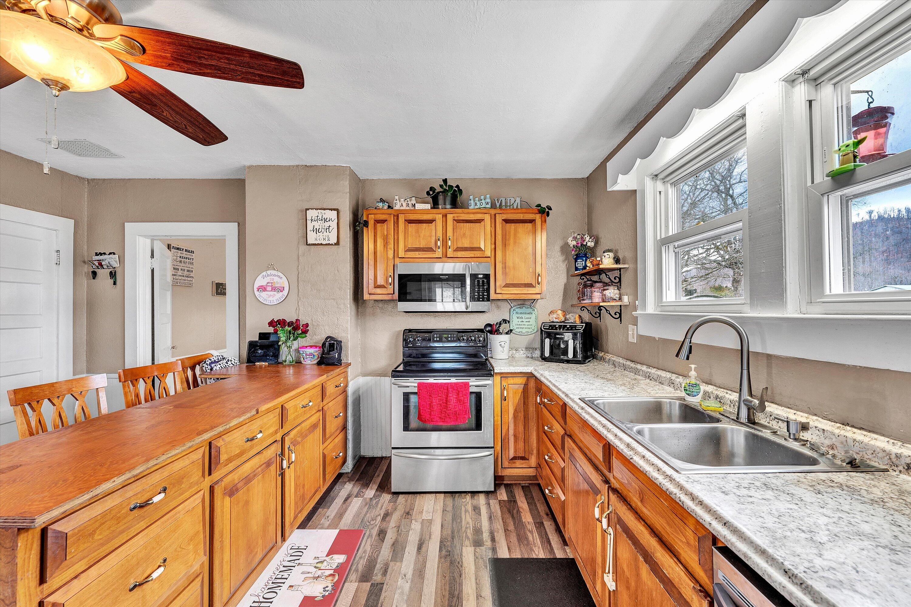 1045 Emerald Drive Goodview, VA 24095 - Photo 14 of 46 a kitchen with sink cabinets and stove