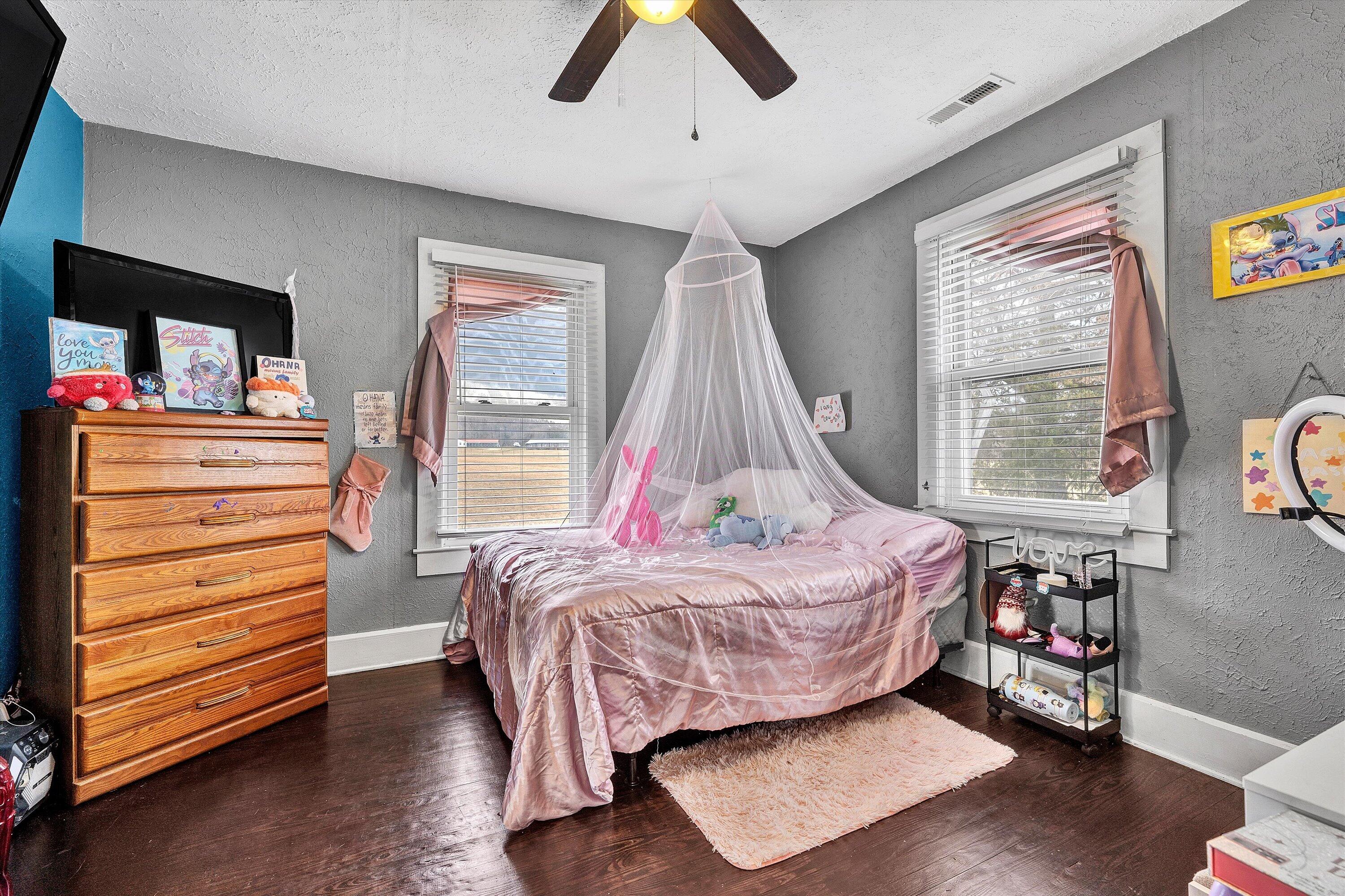 1045 Emerald Drive Goodview, VA 24095 - Photo 23 of 46 a bedroom with a bed and wooden floor