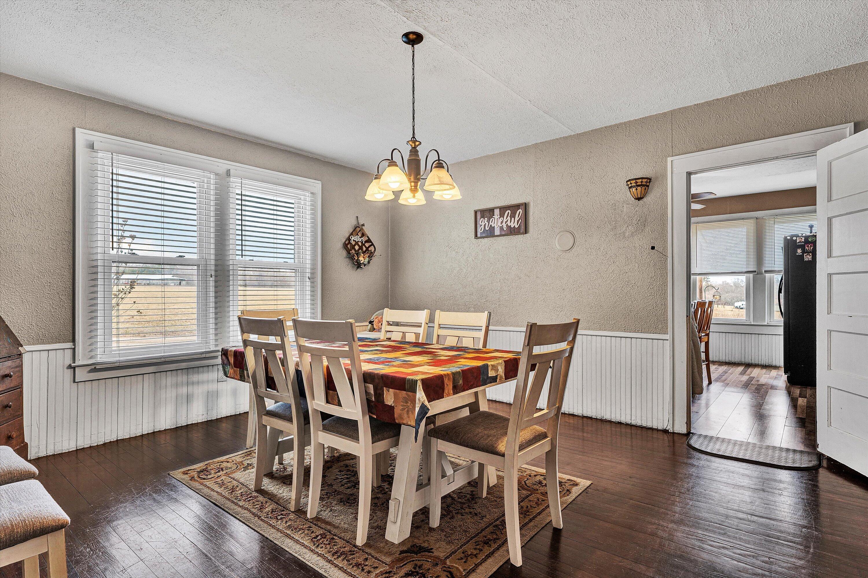1045 Emerald Drive Goodview, VA 24095 - Photo 9 of 46 a view of a dining room with furniture window and wooden floor