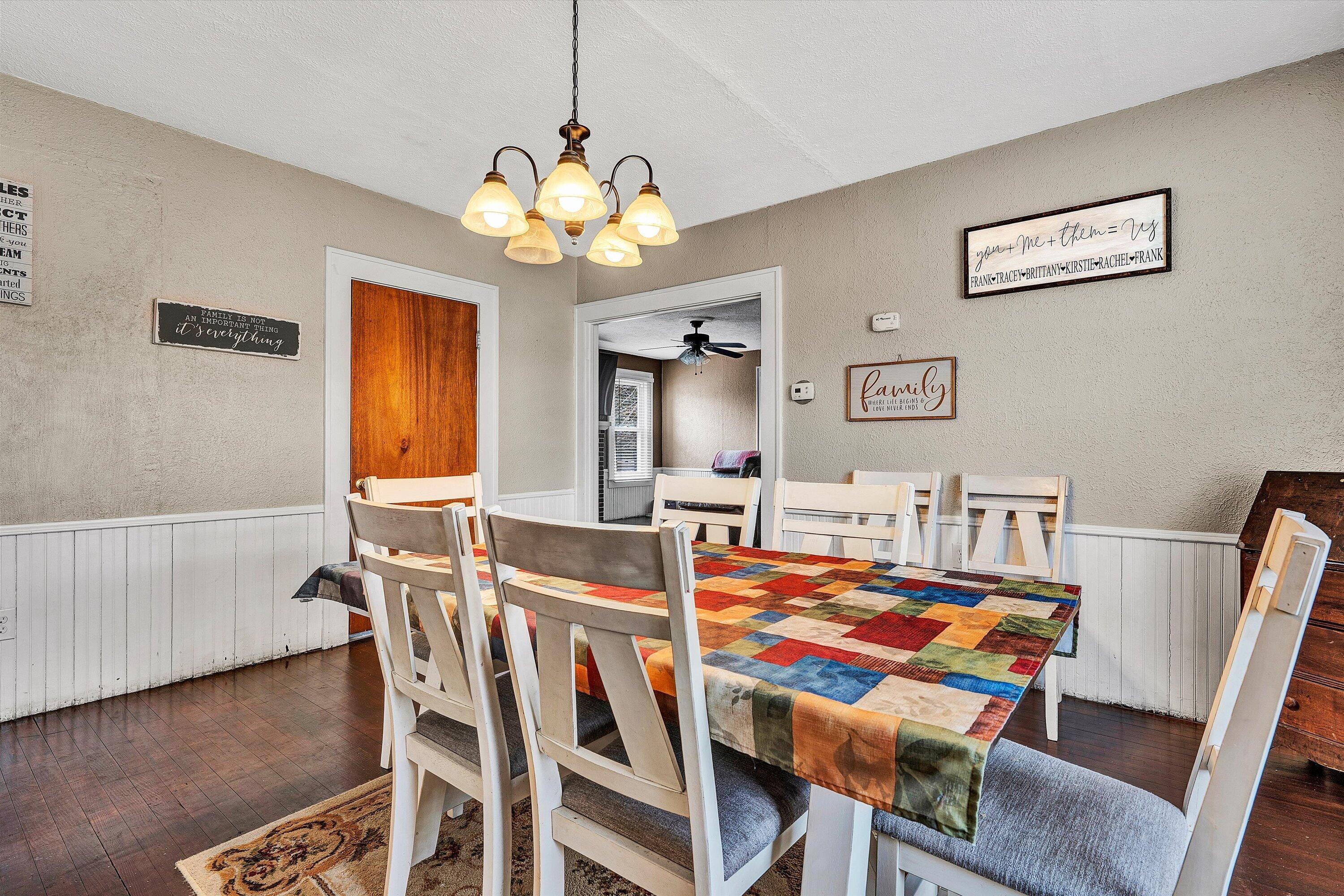 1045 Emerald Drive Goodview, VA 24095 - Photo 10 of 46 a view of a dining room with furniture and chandelier