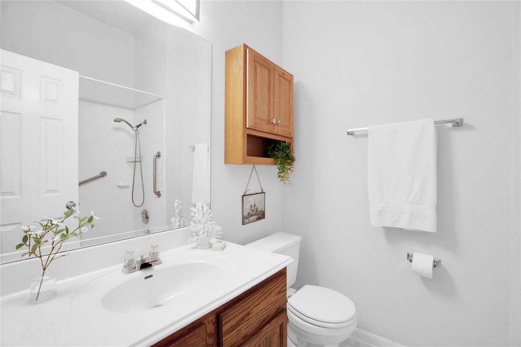 281 Hutton Kyle, TX 78640 - Photo 29 of 37 A pristine bathroom features a single vanity, a standard toilet, and a tiled shower.