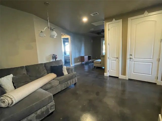 a living room with furniture and a chandelier