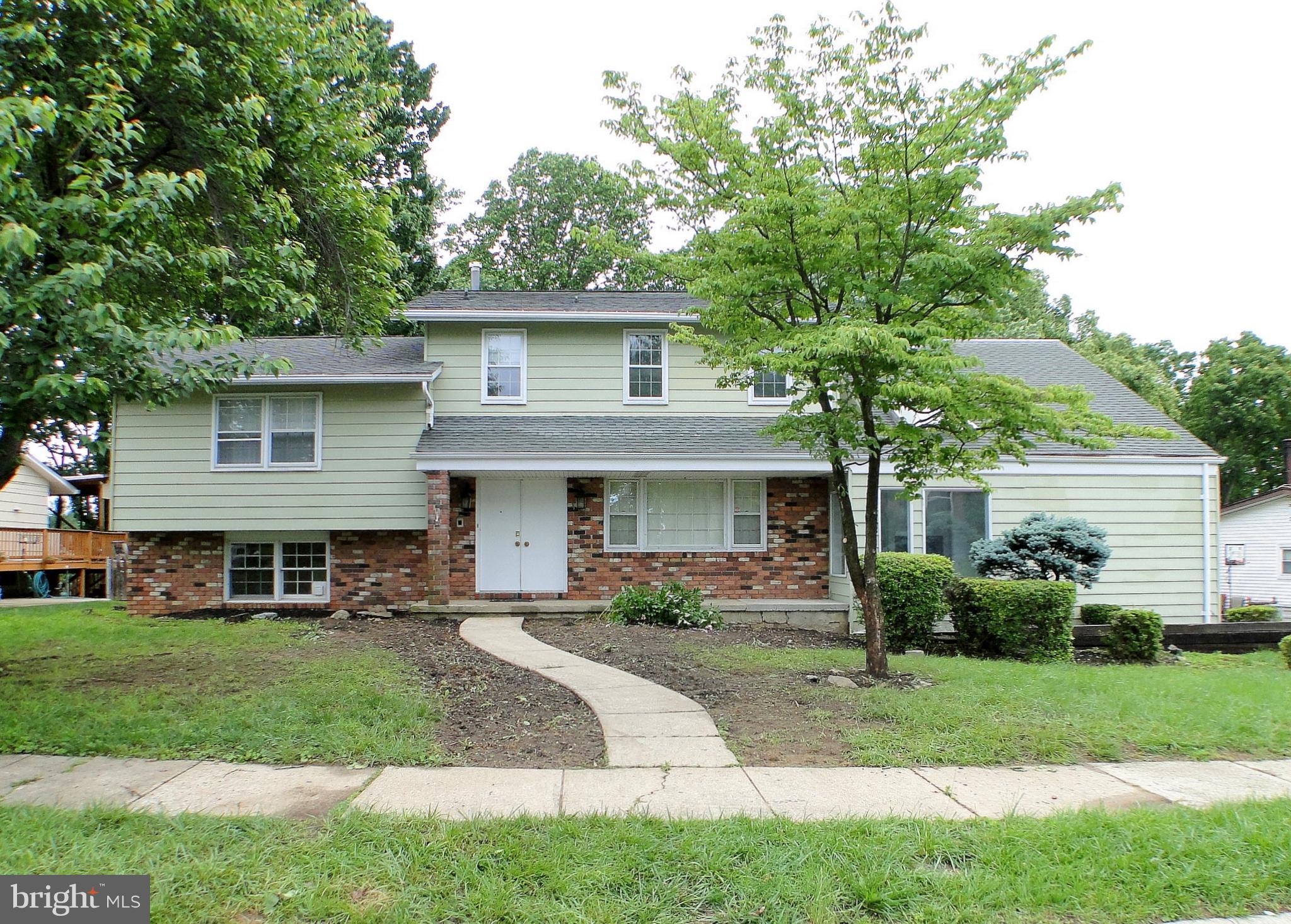 8232 Brattle Road Pikesville, MD 21208 - Photo 1 of 30 a front view of a house with a yard and potted plants