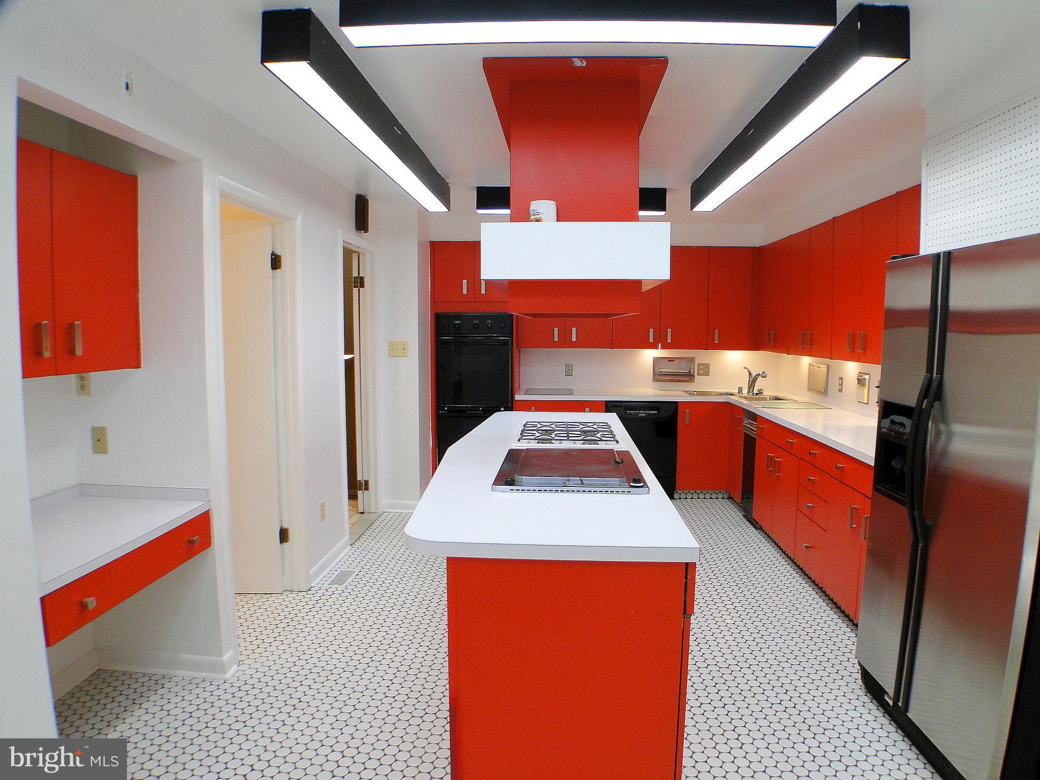 8232 Brattle Road Pikesville, MD 21208 - Photo 11 of 30 a kitchen with a sink a stove and a refrigerator