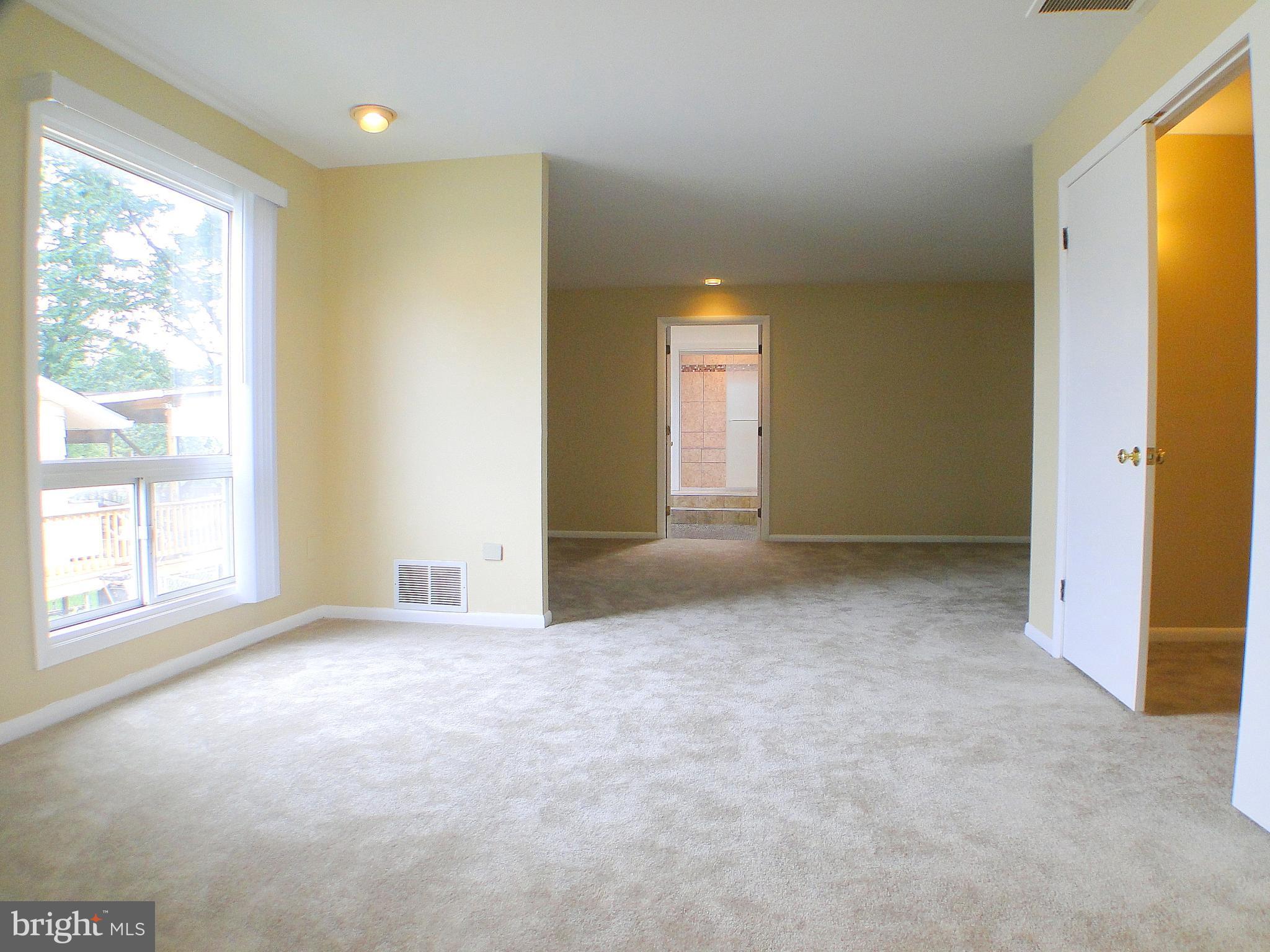 8232 Brattle Road Pikesville, MD 21208 - Photo 19 of 30 an empty room with windows and closet