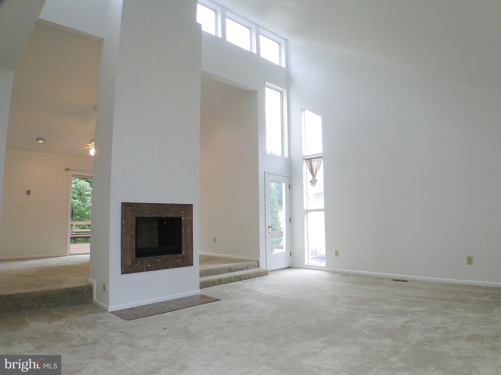 8232 Brattle Road Pikesville, MD 21208 - Photo 5 of 30 a view of empty room with fireplace