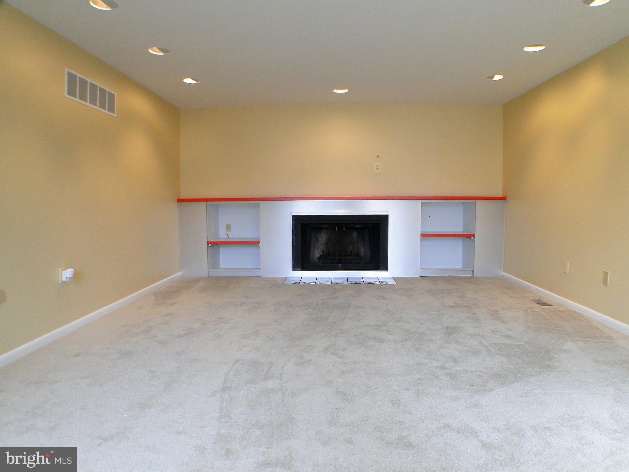 8232 Brattle Road Pikesville, MD 21208 - Photo 9 of 30 a view of an empty room with a fireplace
