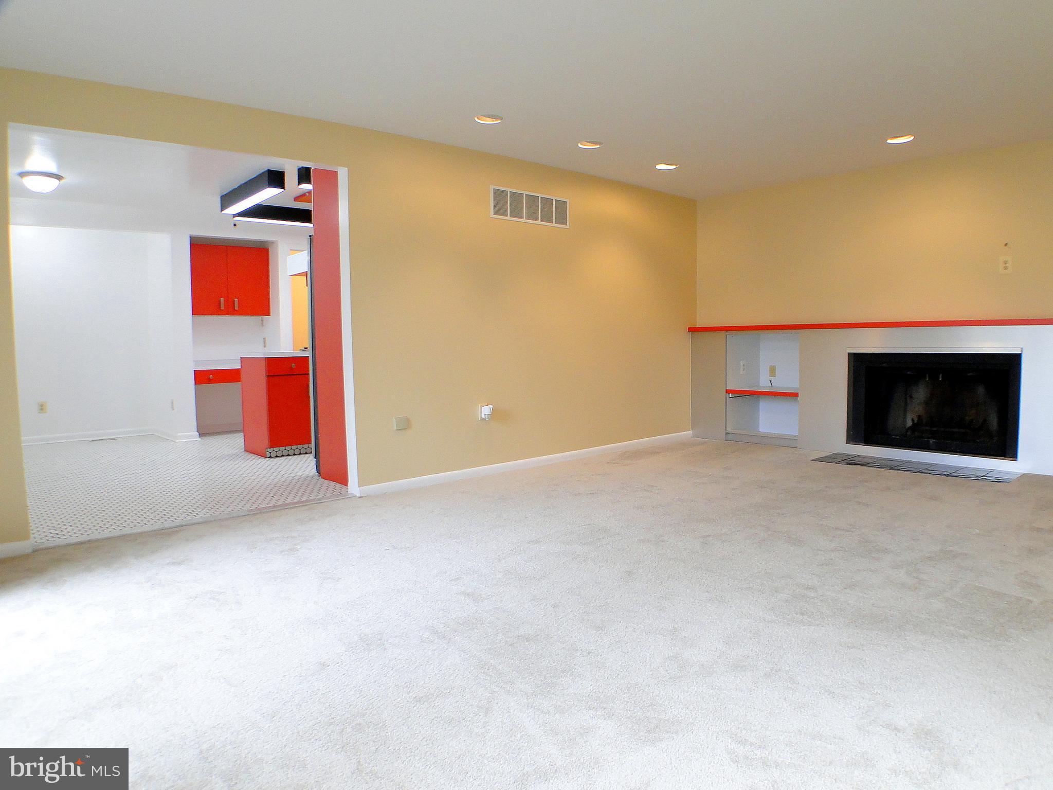 8232 Brattle Road Pikesville, MD 21208 - Photo 10 of 30 an empty room with furniture and a fireplace