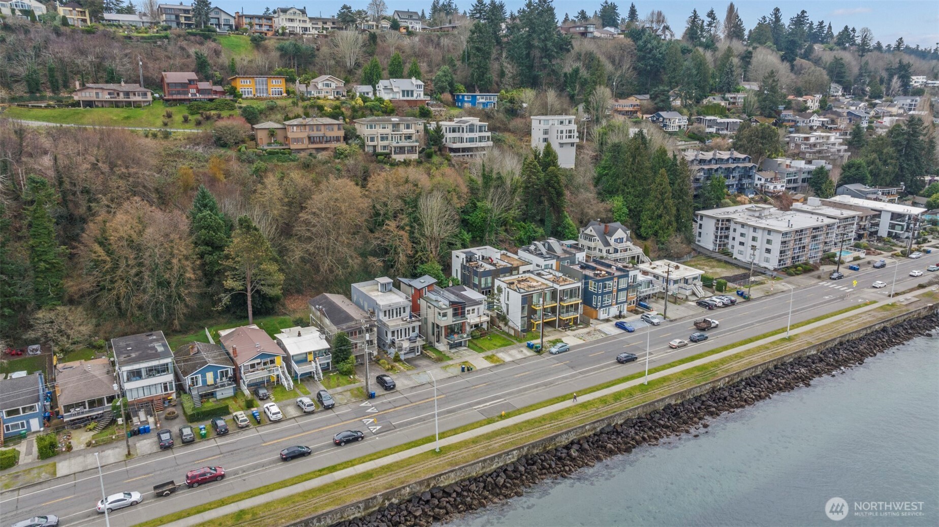 1768 Alki Avenue Southwest Seattle, WA 98116 - Photo 12 of 40 a view of a lake with a couple of cars parked on the road
