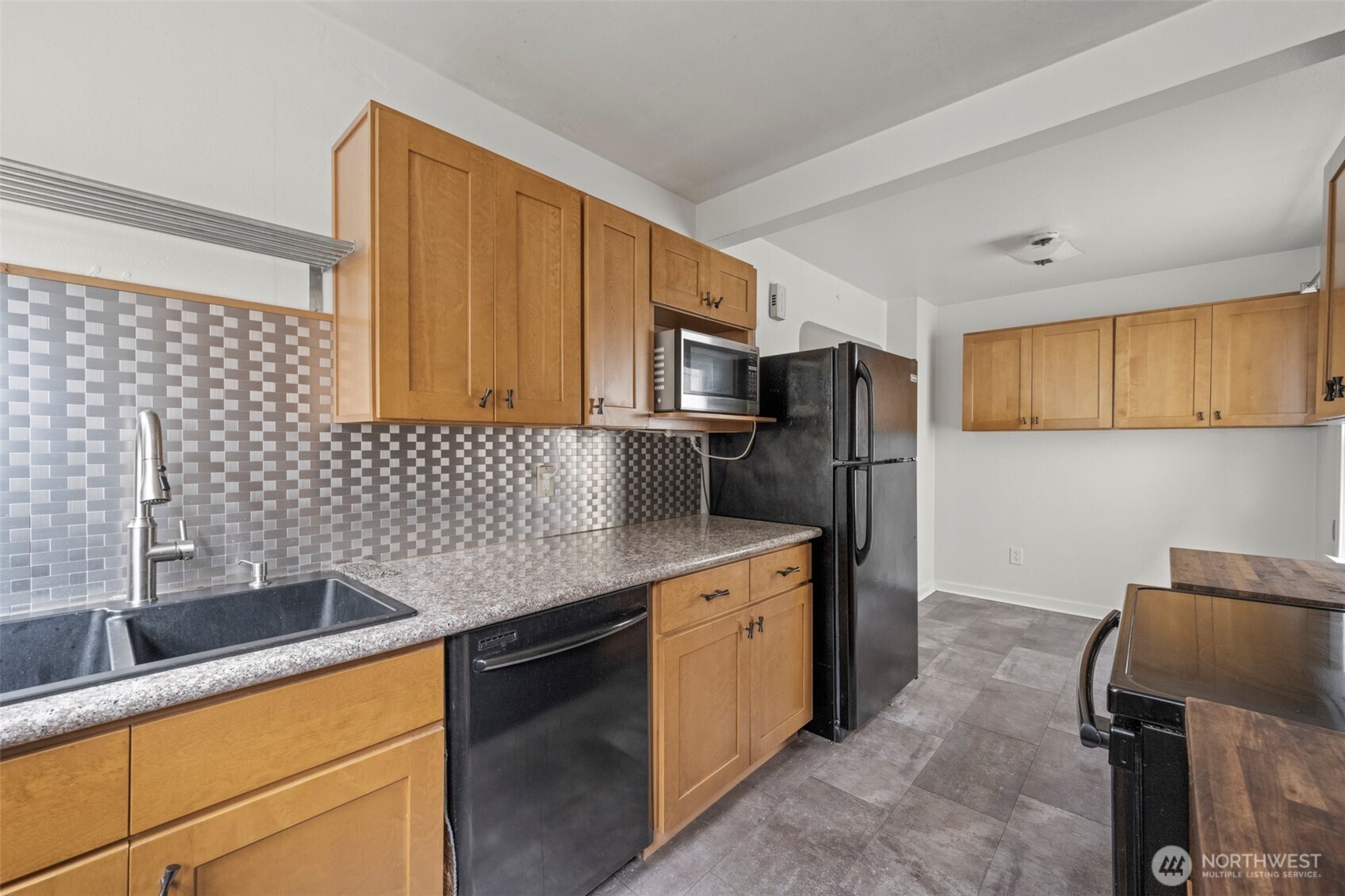 1768 Alki Avenue Southwest Seattle, WA 98116 - Photo 22 of 40 a kitchen with stainless steel appliances a sink cabinets and a counter top space