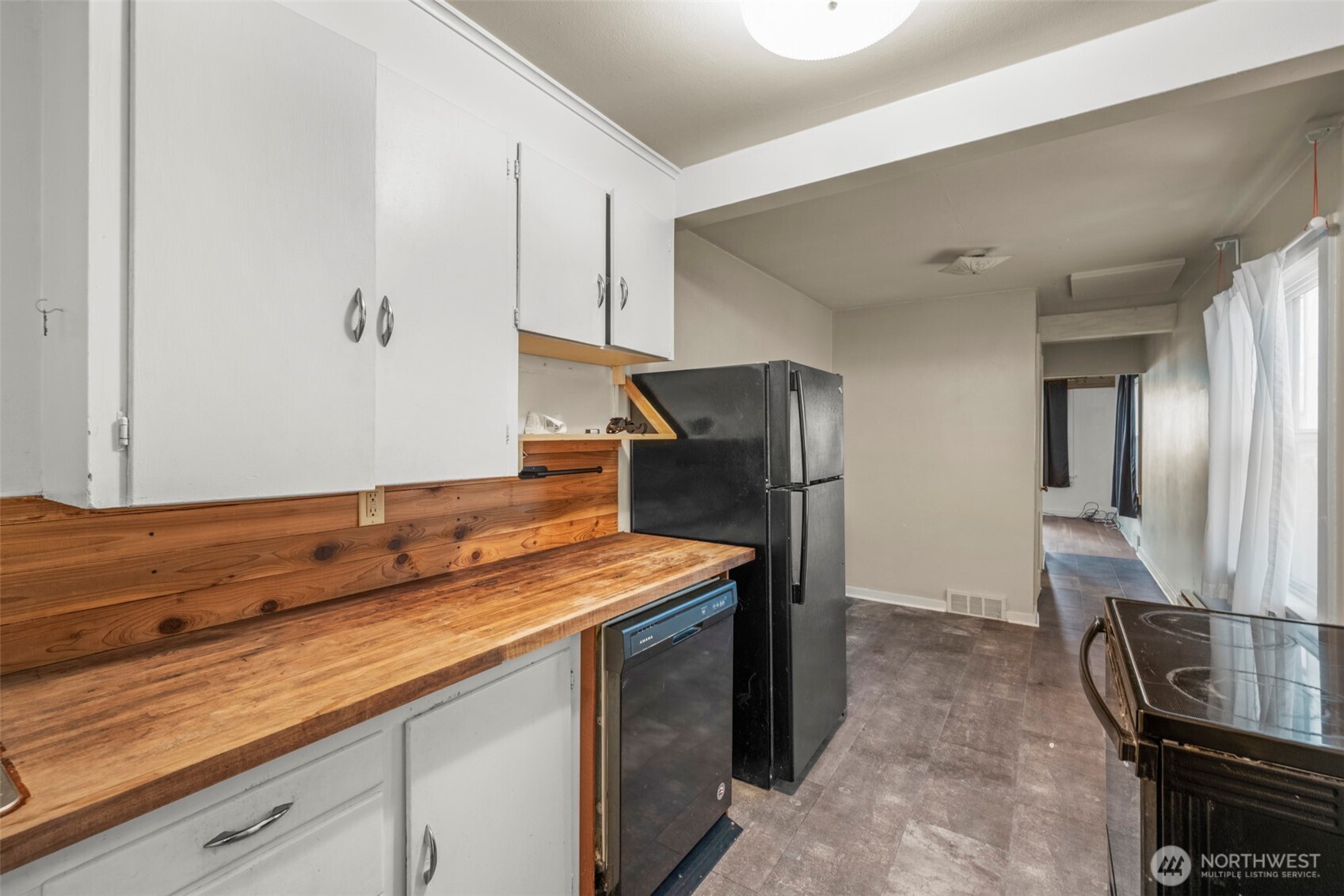 1768 Alki Avenue Southwest Seattle, WA 98116 - Photo 31 of 40 a kitchen with stainless steel appliances granite countertop a sink and a stove