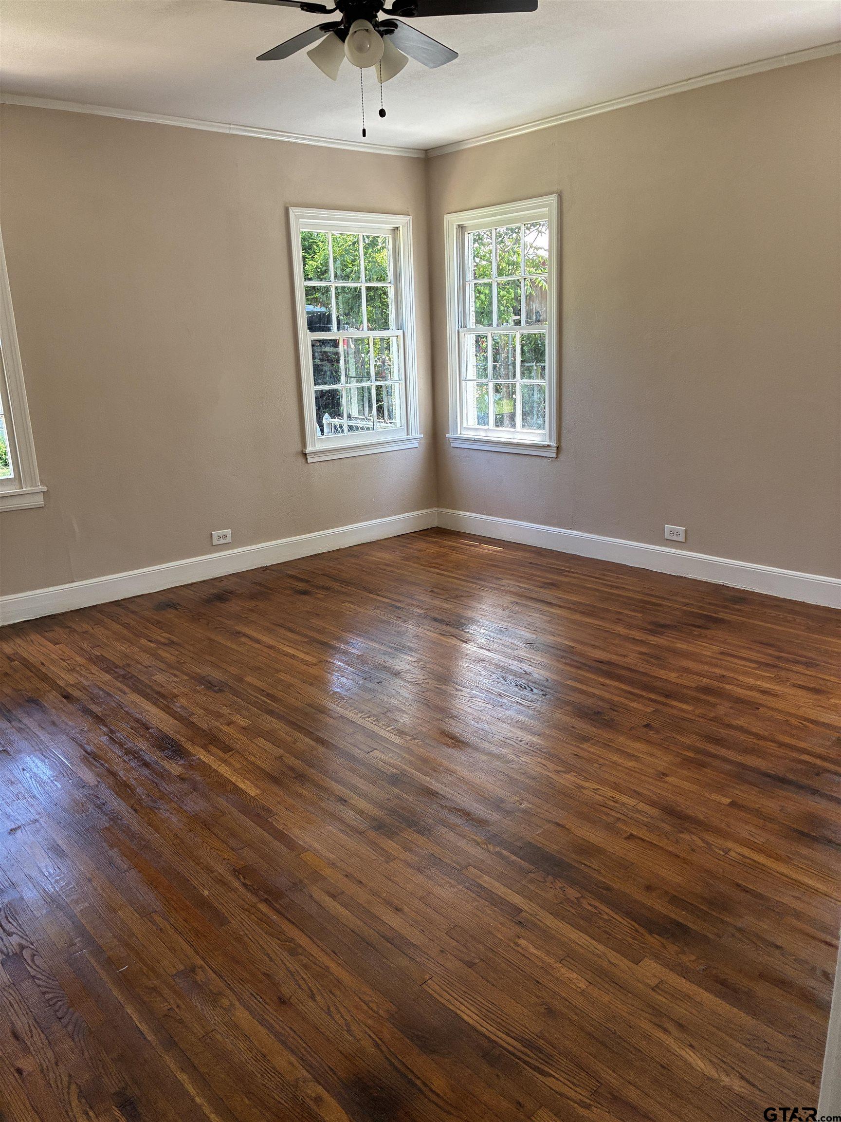 811 West 5th Street Tyler, TX 75701 - Photo 10 of 26 an empty room with wooden floor and windows