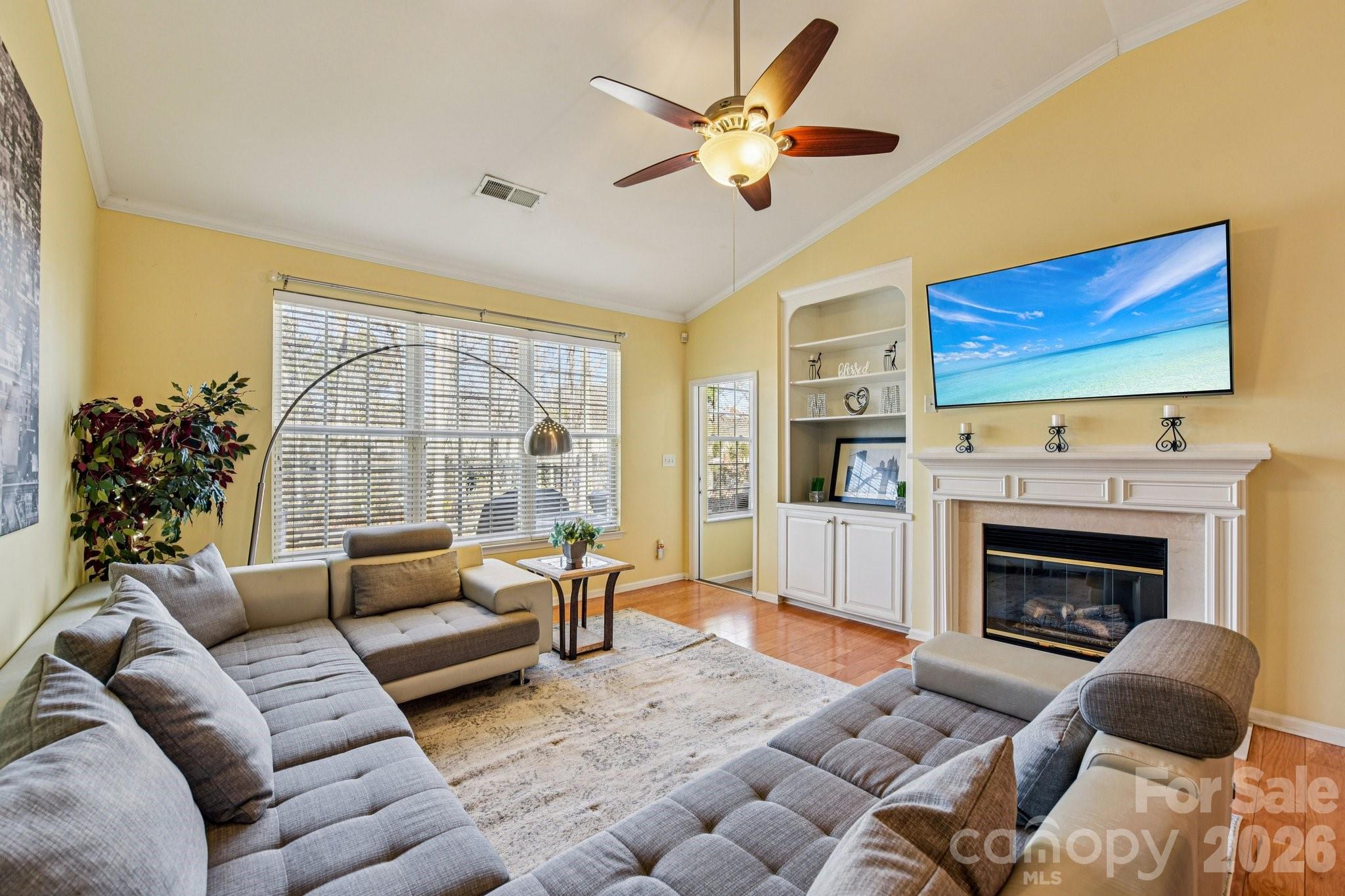 4700 Willow Glen Road Harrisburg, NC 28075 - Photo 11 of 29 a living room with furniture fireplace and a flat screen tv
