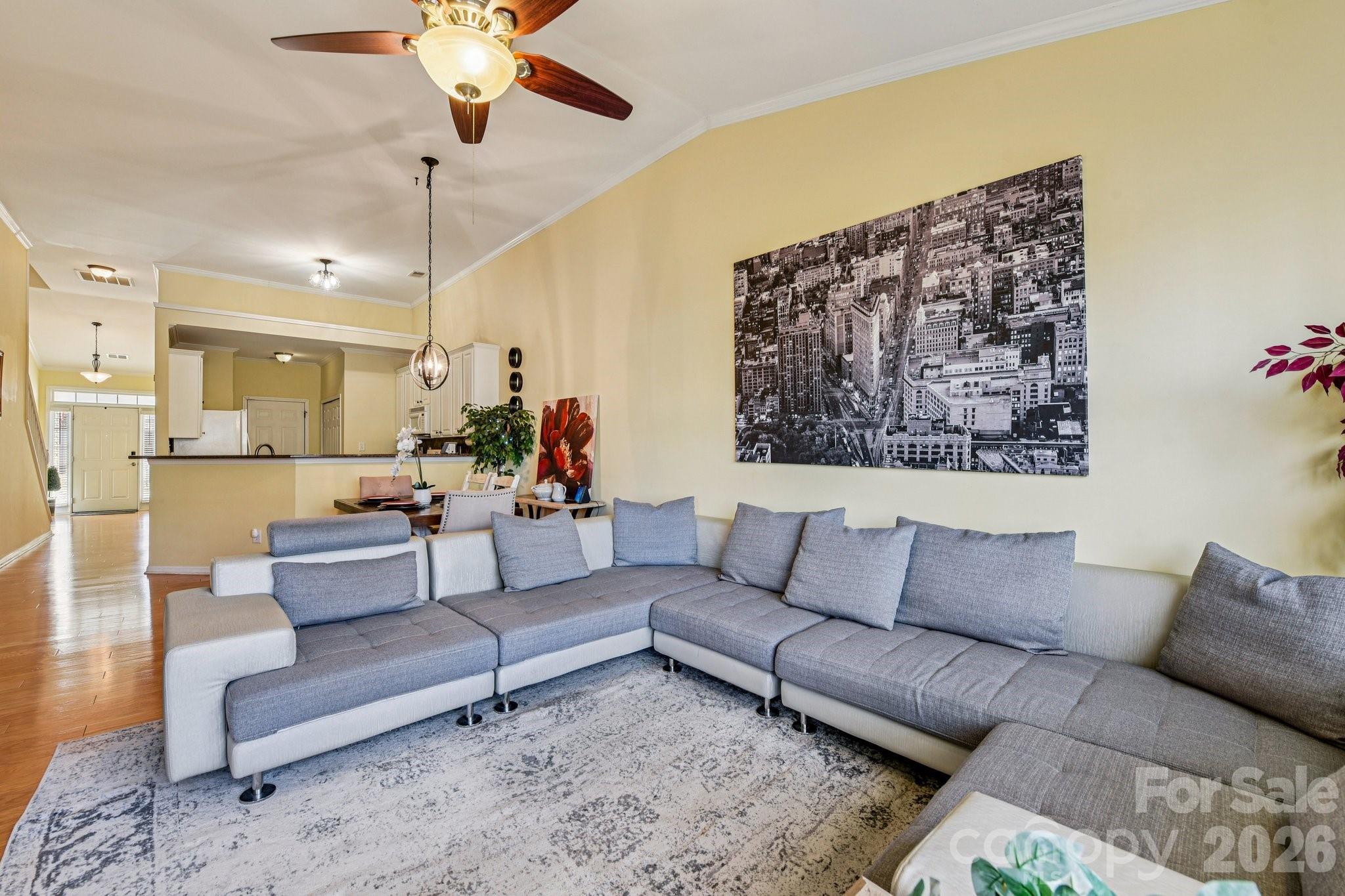 4700 Willow Glen Road Harrisburg, NC 28075 - Photo 12 of 29 a living room with furniture and a chandelier