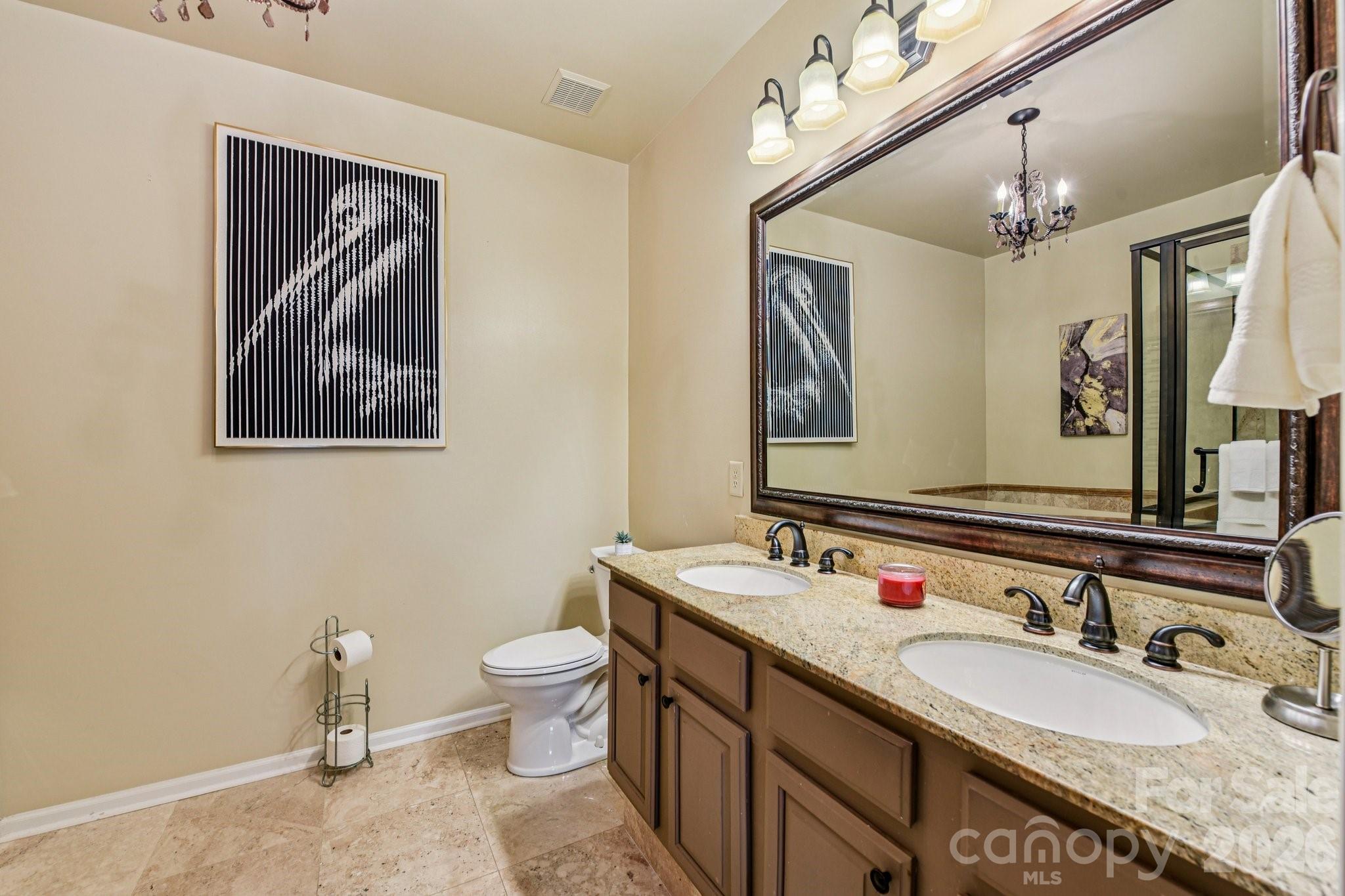 4700 Willow Glen Road Harrisburg, NC 28075 - Photo 17 of 29 a bathroom with a granite countertop sink mirror vanity and toilet