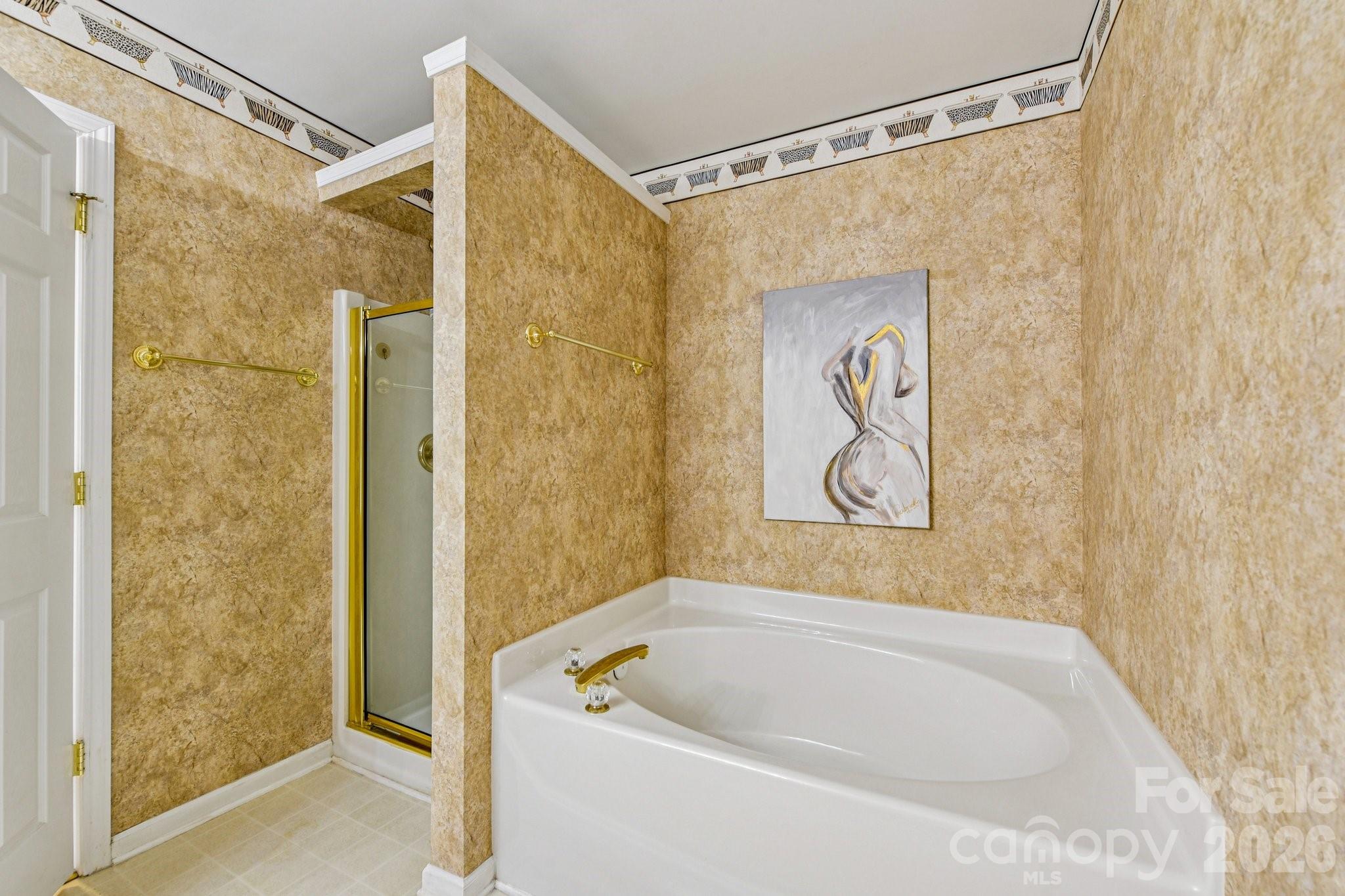 4700 Willow Glen Road Harrisburg, NC 28075 - Photo 19 of 29 a bathroom with a shower and a bathtub