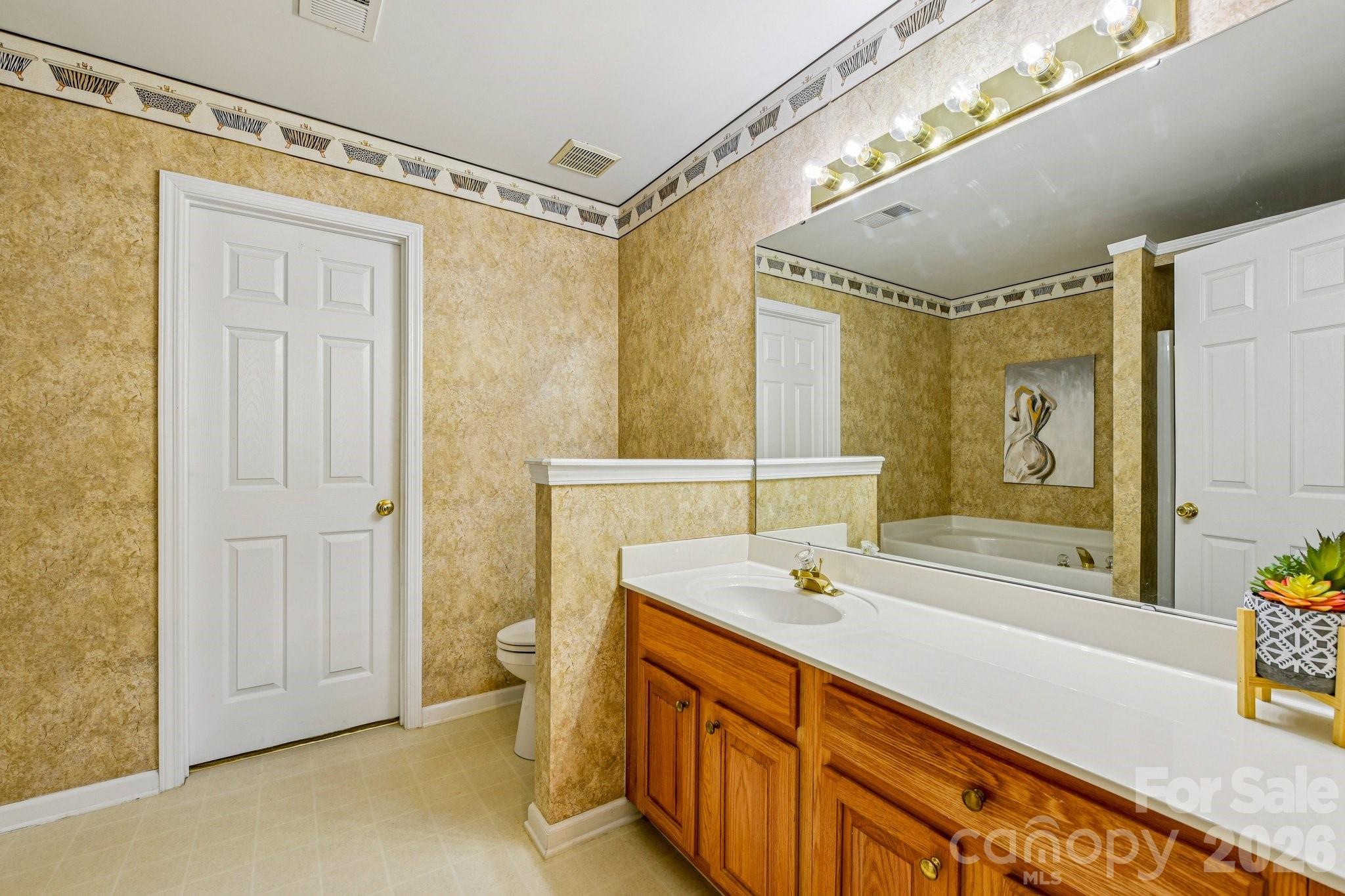 4700 Willow Glen Road Harrisburg, NC 28075 - Photo 20 of 29 a spacious bathroom with a double vanity sink a mirror and a shower