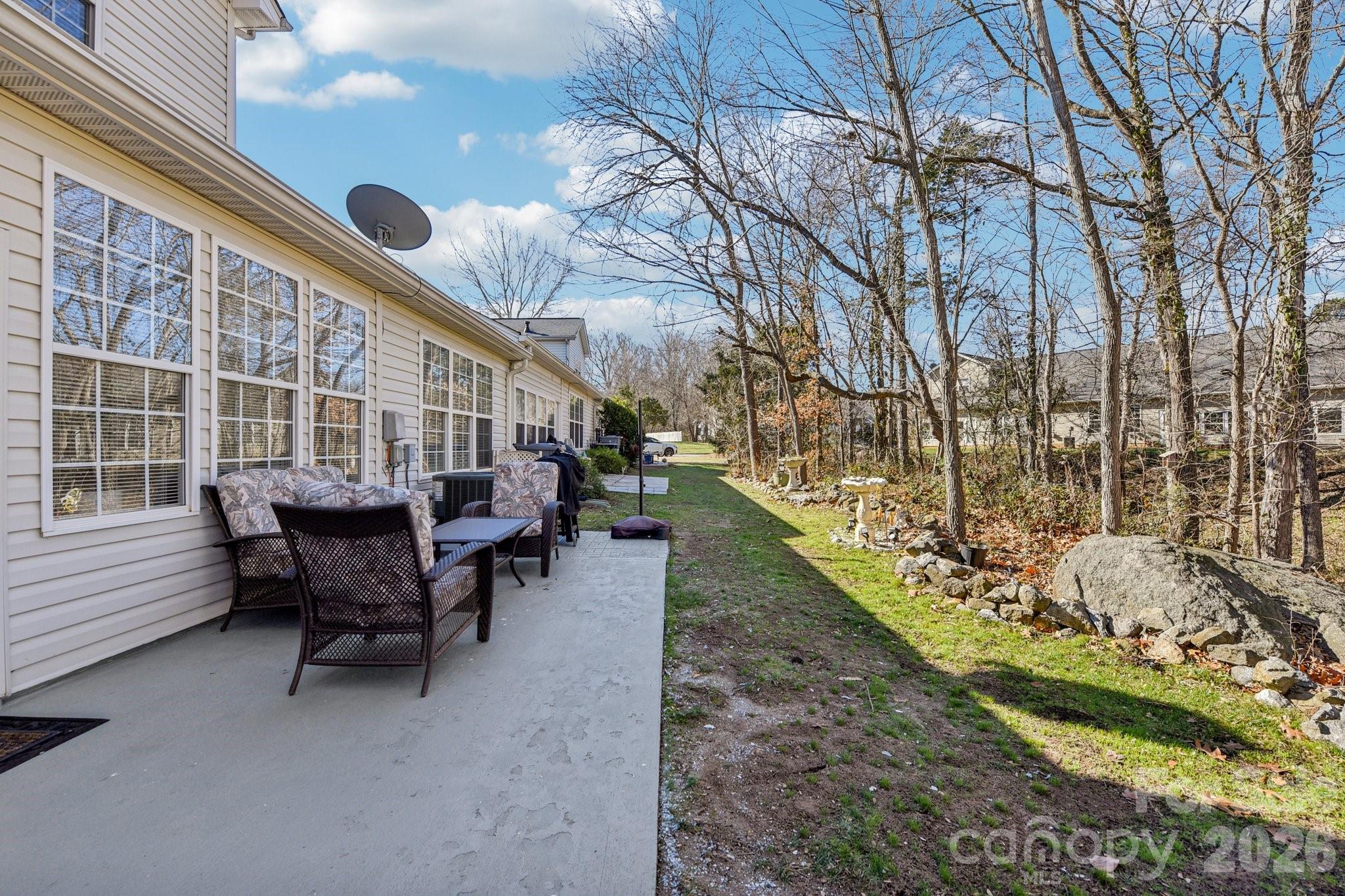 4700 Willow Glen Road Harrisburg, NC 28075 - Photo 25 of 29 a view of a house with backyard and sitting area