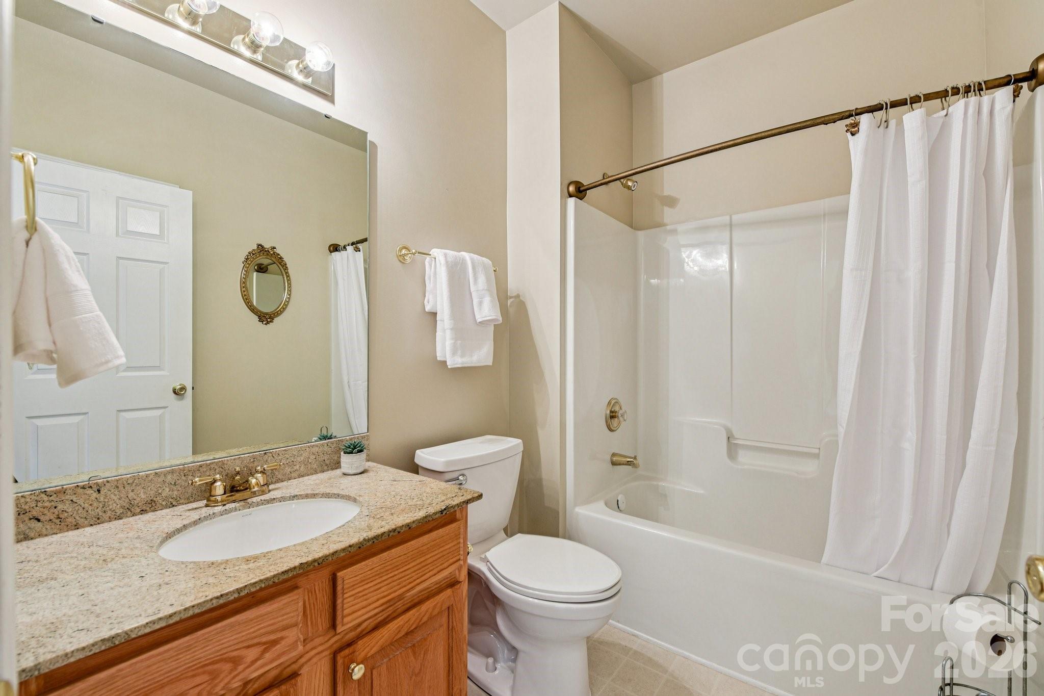4700 Willow Glen Road Harrisburg, NC 28075 - Photo 5 of 29 a bathroom with a granite countertop sink toilet and shower