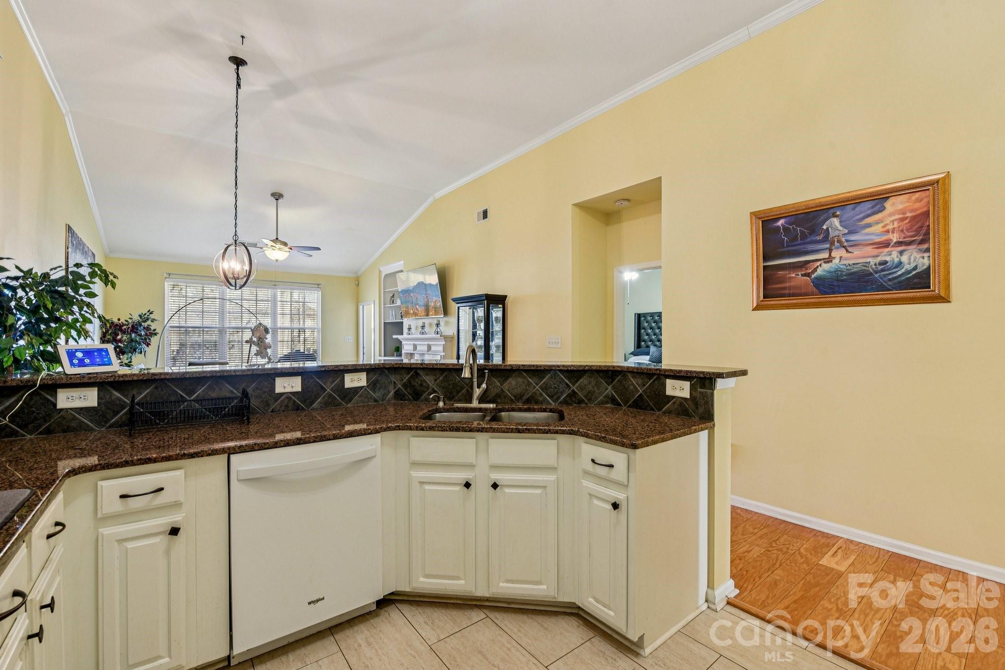 4700 Willow Glen Road Harrisburg, NC 28075 - Photo 6 of 29 a kitchen with granite countertop a sink and white cabinets