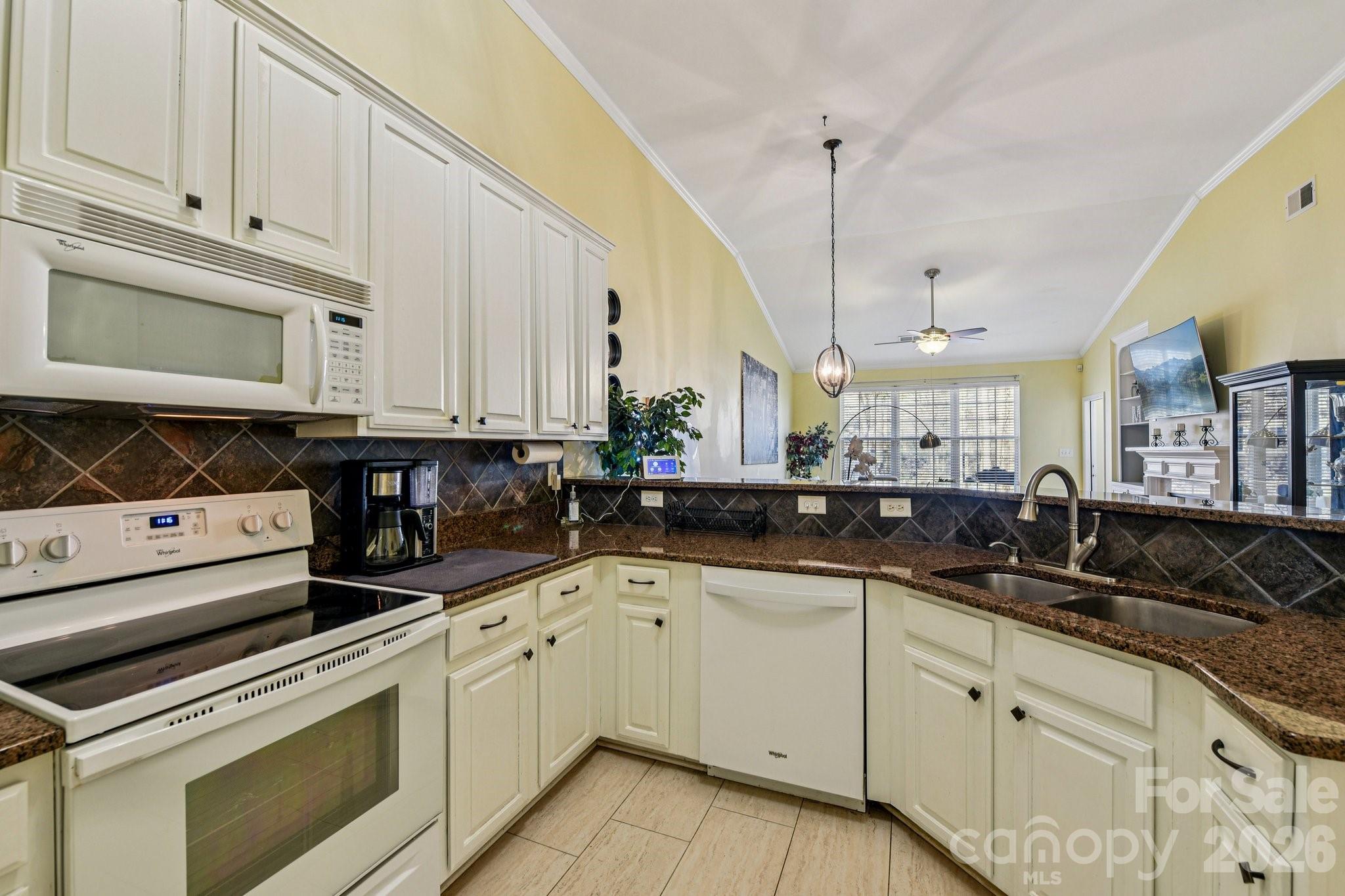 4700 Willow Glen Road Harrisburg, NC 28075 - Photo 7 of 29 a kitchen with granite countertop a sink a stove and cabinets