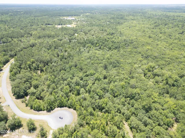 a view of a field with an ocean view