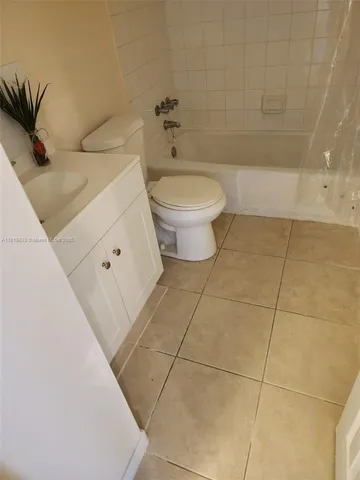 a bathroom with a toilet and a bathtub