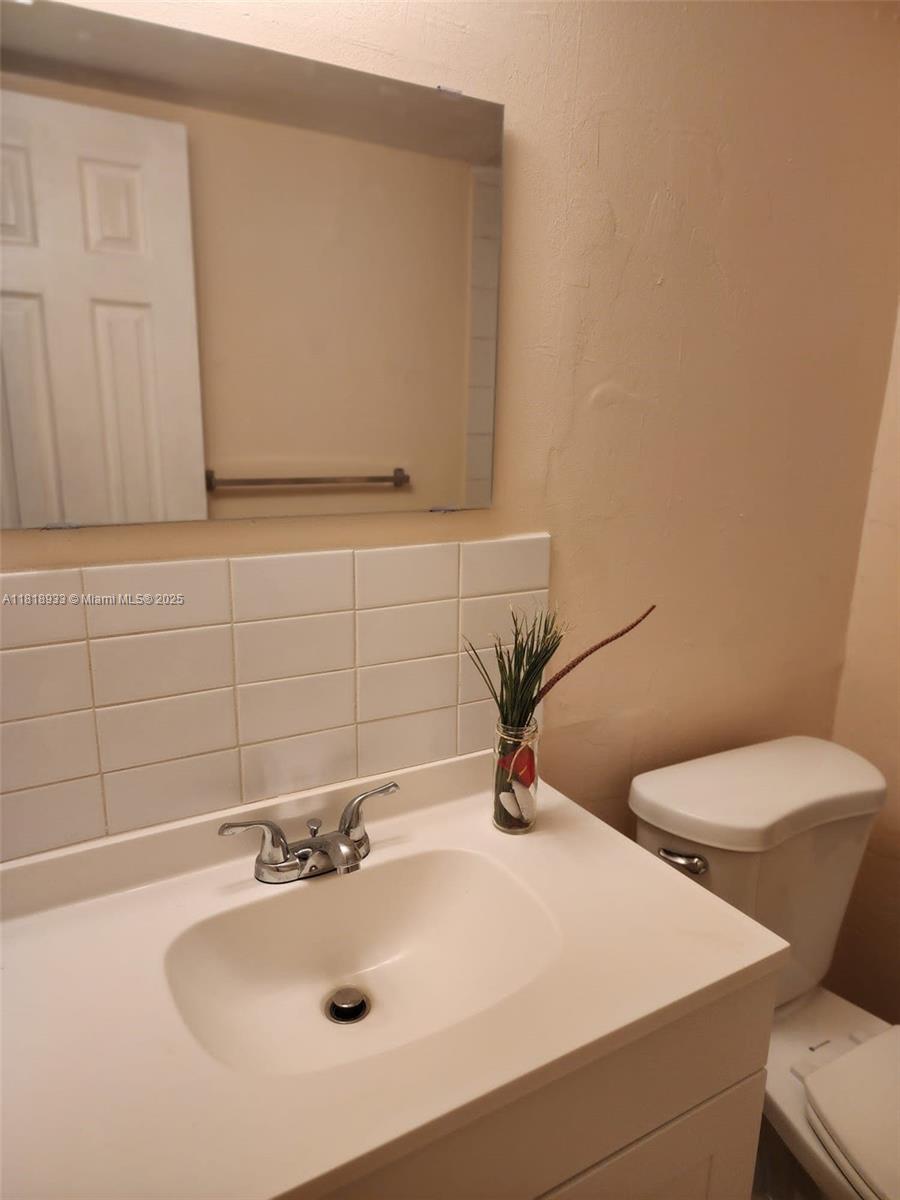 Snug Harbor Pompano Beach, FL 33060 - Photo 7 of 16 a bathroom with a sink and a mirror