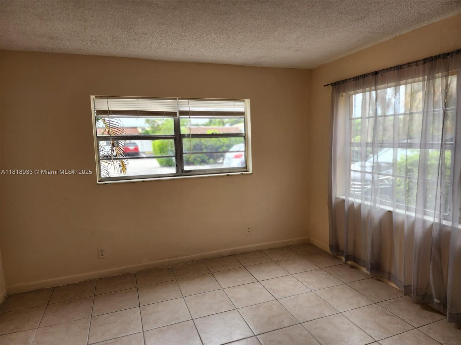 Snug Harbor Pompano Beach, FL 33060 - Photo 9 of 16 a view of an empty room with a window