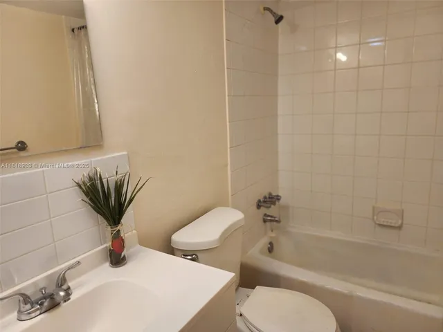 a bathroom with a toilet sink and bathtub