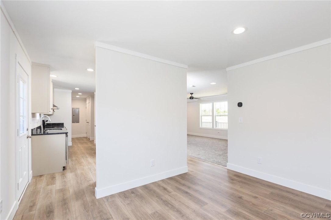 2011 Meherrin Road Meherrin, VA 23954 - Photo 16 of 37 an empty room with wooden floor and a kitchen