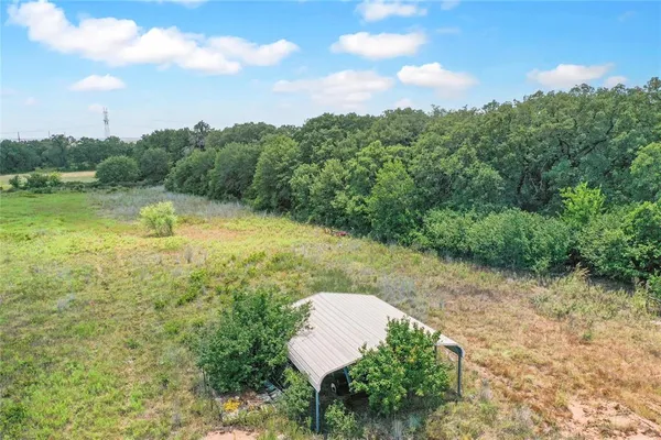 a view of a water pond with green yard