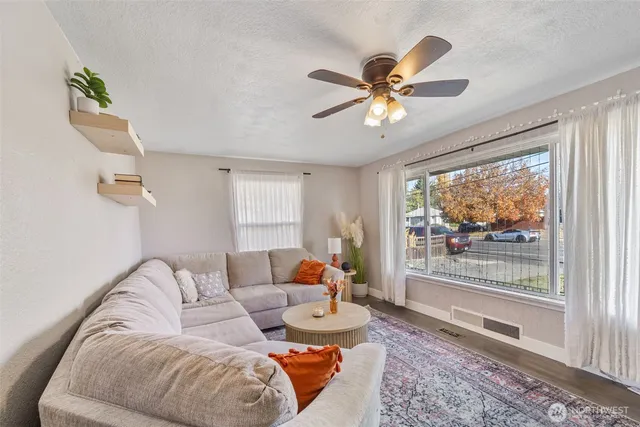 a living room with furniture and a large window