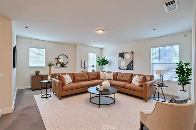 a bedroom with a bed a mirror and lamp next to a window