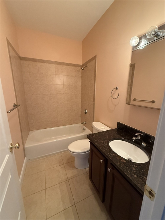 40 Heather Street, Unit 204 Beverly, MA 01915 - Photo 16 of 39 a bathroom with a granite countertop sink toilet mirror bathtub and shower