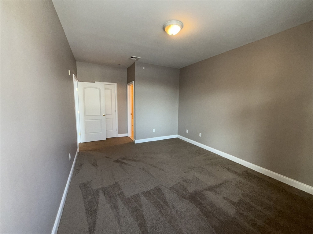 40 Heather Street, Unit 204 Beverly, MA 01915 - Photo 18 of 39 an empty room with a natural light