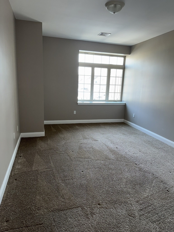 40 Heather Street, Unit 204 Beverly, MA 01915 - Photo 19 of 39 an empty room with a empty space and a window