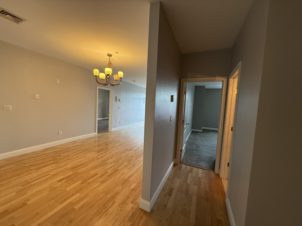 40 Heather Street, Unit 204 Beverly, MA 01915 - Photo 8 of 39 a view of a hallway with wooden floor