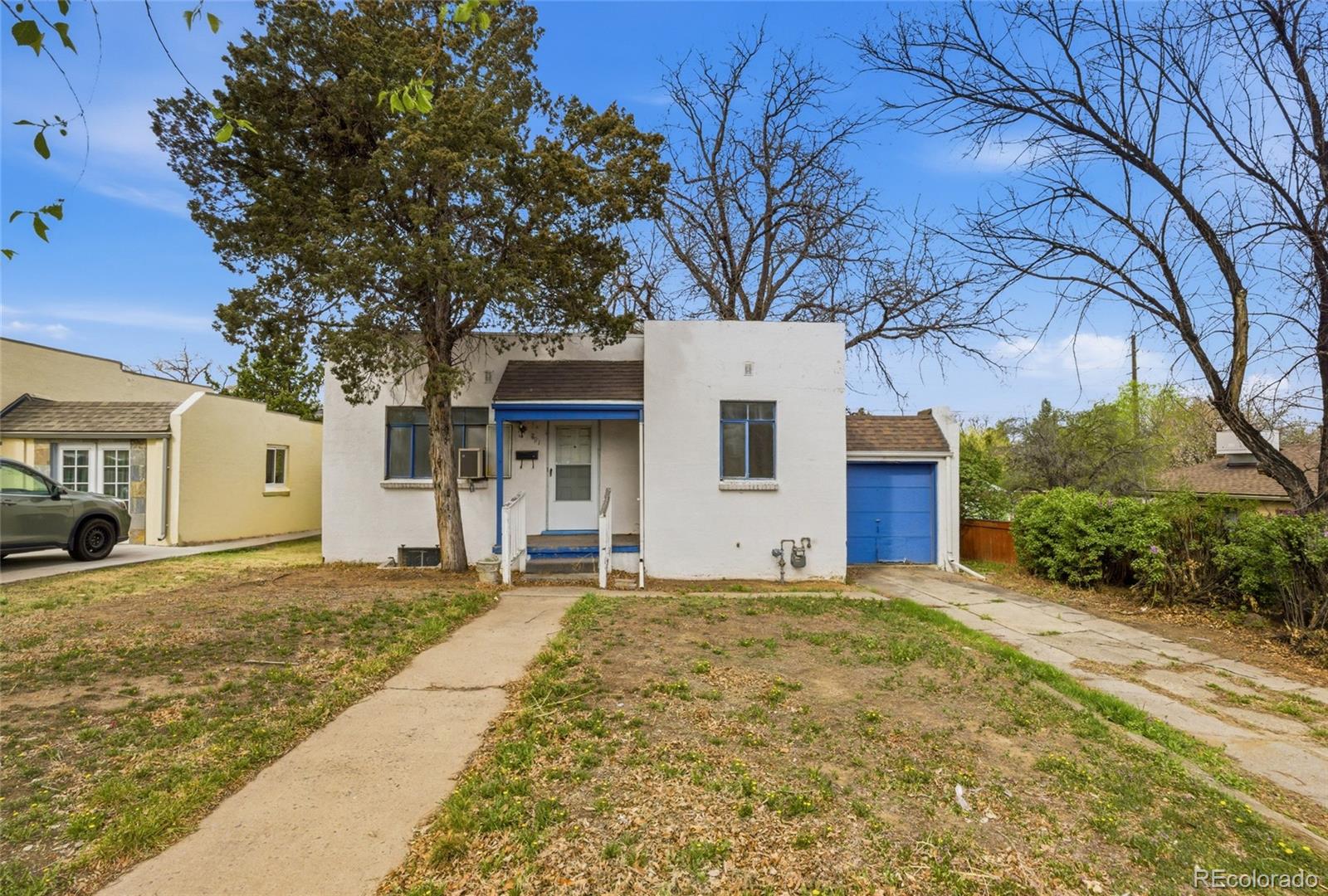 791 Quebec Street Denver, CO 80220 - Photo 2 of 17 a front view of a house with a yard and garage