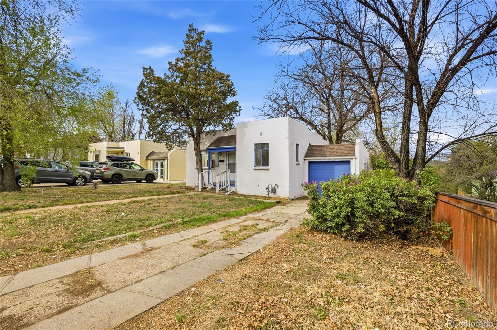 791 Quebec Street Denver, CO 80220 - Photo 3 of 17 a yellow house with trees in front of it