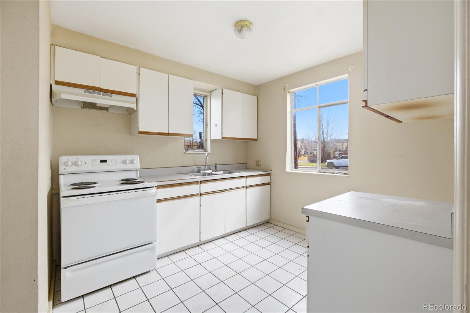 791 Quebec Street Denver, CO 80220 - Photo 4 of 17 a kitchen with a sink cabinets and window
