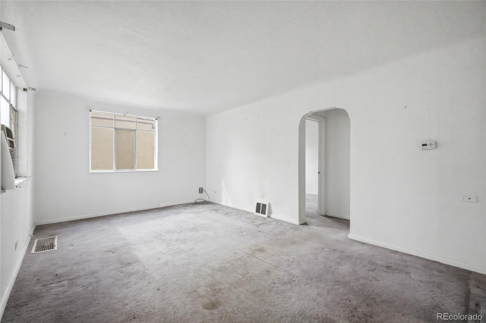 791 Quebec Street Denver, CO 80220 - Photo 6 of 17 an empty room with windows and closet