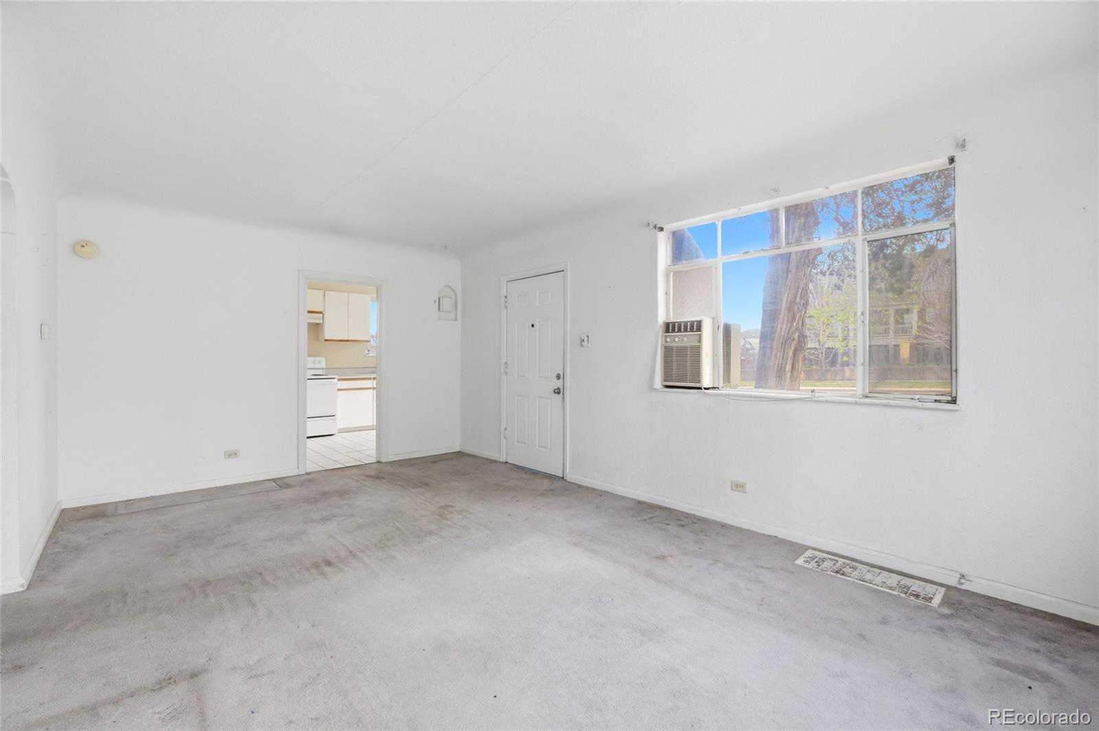 791 Quebec Street Denver, CO 80220 - Photo 7 of 17 a view of an empty room with a window