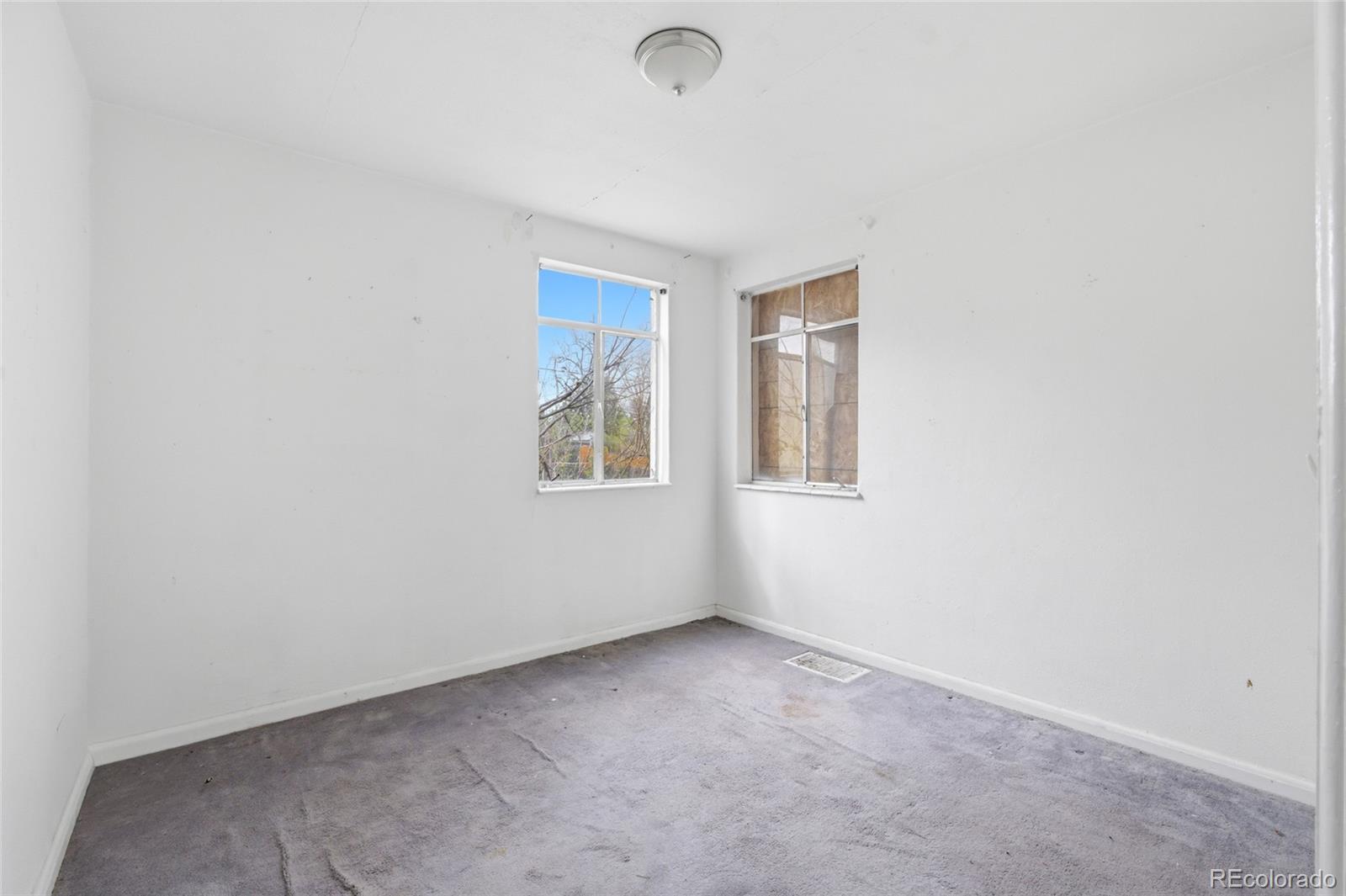 791 Quebec Street Denver, CO 80220 - Photo 8 of 17 an empty room with windows