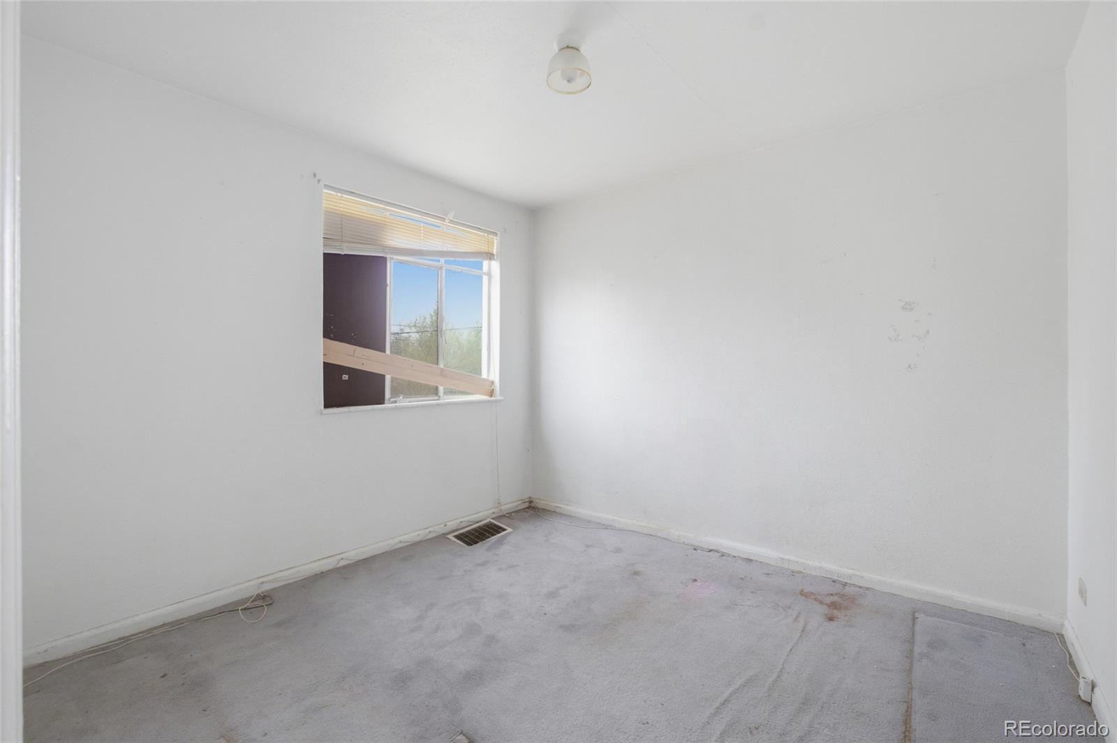 791 Quebec Street Denver, CO 80220 - Photo 10 of 17 a view of an empty room with a window