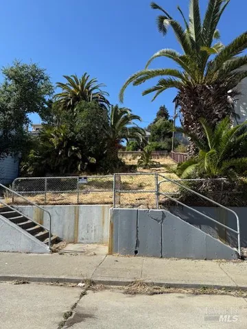 a view of a yard with snow on the road
