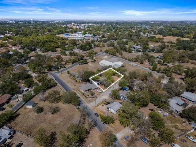 an aerial view of a house with a yard