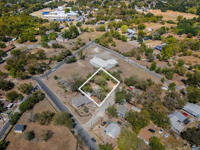 an aerial view of a residential houses with outdoor space